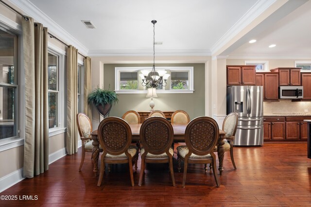 33 Little Pine Ct, Bluffton, SC 29910 - dining space featuring crown molding, dark wood-style flooring, a chandelier, and visible vents