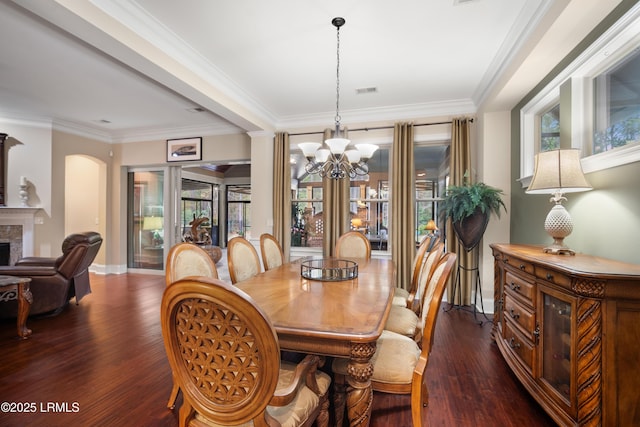 33 Little Pine Ct, Bluffton, SC 29910 - dining area featuring a fireplace, baseboards, dark wood-style flooring, and an inviting chandelier