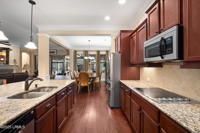 33 Little Pine Ct, Bluffton, SC 29910 - kitchen featuring stainless steel appliances, a sink, light stone countertops, a chandelier, and dark wood-style flooring