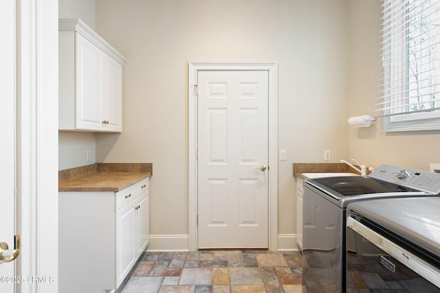 67 Winding Oak Dr, Okatie, SC 29909 - laundry area featuring cabinet space, washing machine and clothes dryer, light stone finish flooring, and baseboards