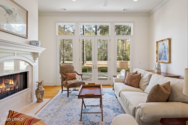 67 Winding Oak Dr, Okatie, SC 29909 - living area with wood finished floors, a fireplace, plenty of natural light, and crown molding