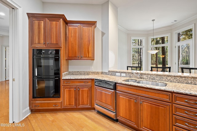 67 Winding Oak Dr, Okatie, SC 29909 - kitchen featuring paneled dishwasher, light wood-style flooring, a sink, light stone counters, and brown cabinetry