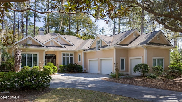 67 Winding Oak Dr, Okatie, SC 29909 - view of front of property featuring stucco siding, concrete driveway, an attached garage, and a chimney