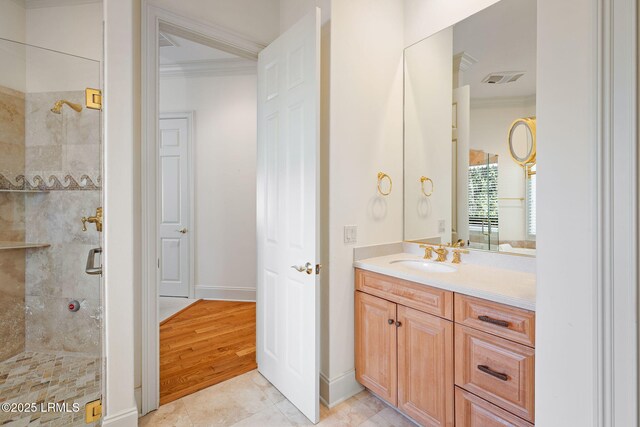 67 Winding Oak Dr, Okatie, SC 29909 - bathroom featuring a tile shower, ornamental molding, vanity, baseboards, and tile patterned floors