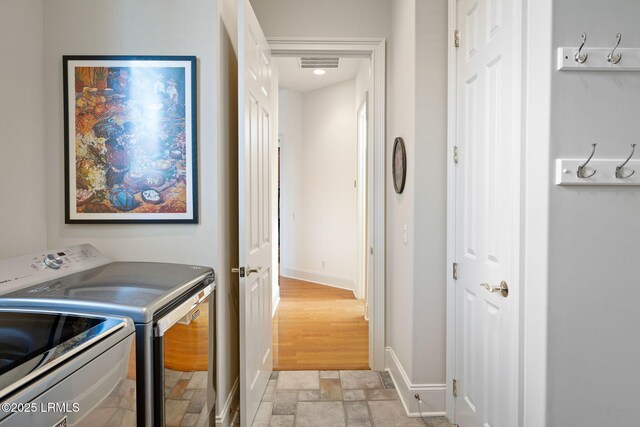 67 Winding Oak Dr, Okatie, SC 29909 - laundry room featuring washer and clothes dryer, stone tile floors, and baseboards