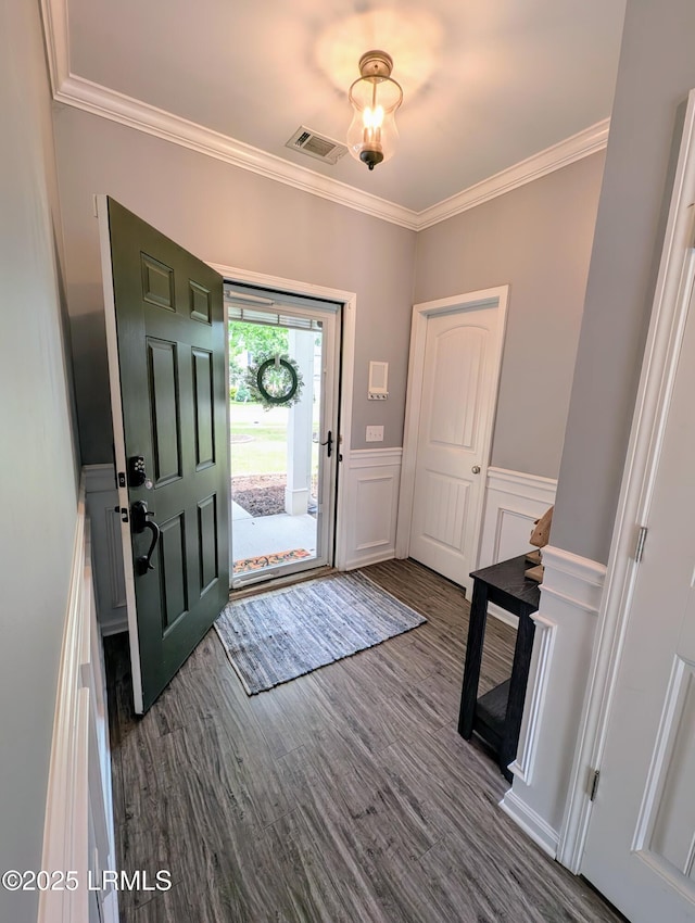 120 Wall St, Savannah, GA 31405 - foyer featuring dark wood finished floors, ornamental molding, a wainscoted wall, and a decorative wall