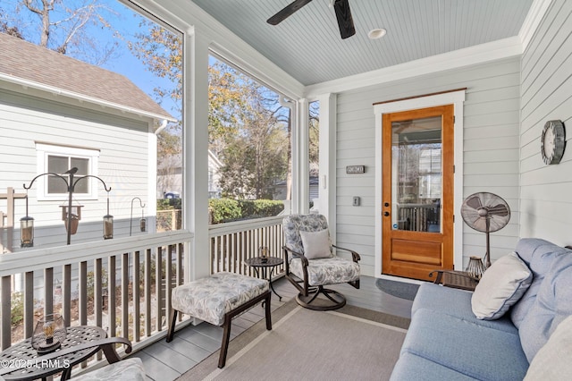 sunroom / solarium featuring ceiling fan