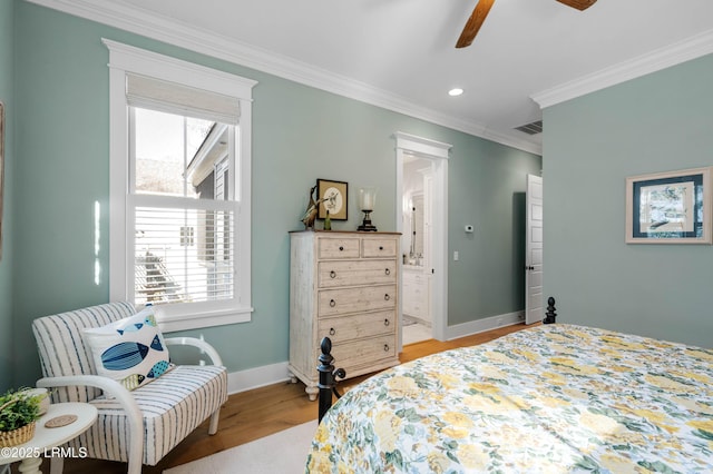 bedroom with multiple windows, ornamental molding, ensuite bathroom, and light hardwood / wood-style flooring