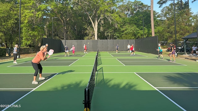 view of tennis court with basketball hoop