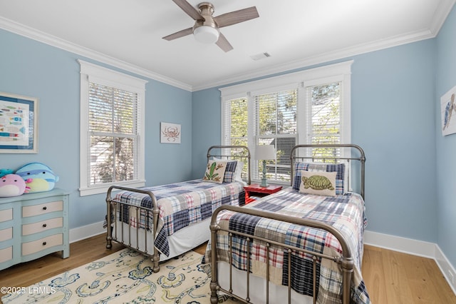 bedroom with ceiling fan, ornamental molding, and light hardwood / wood-style floors