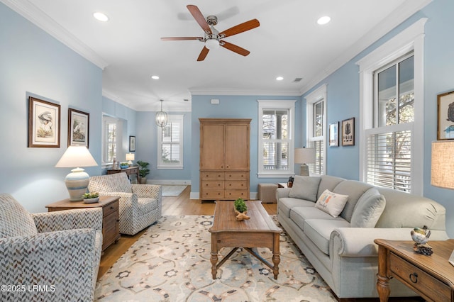 living room featuring ornamental molding, ceiling fan, and light hardwood / wood-style floors