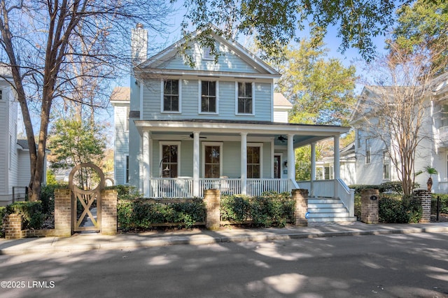 neoclassical home with ceiling fan and a porch