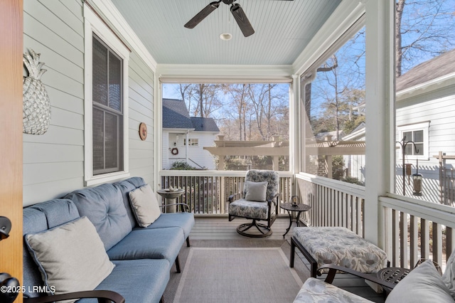 sunroom / solarium featuring ceiling fan