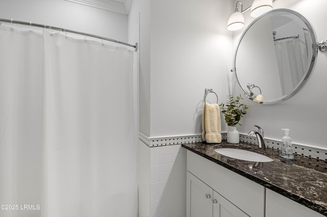 bathroom with vanity, tile walls, and crown molding