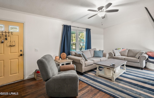 living room featuring dark hardwood / wood-style flooring, ceiling fan, crown molding, and a textured ceiling