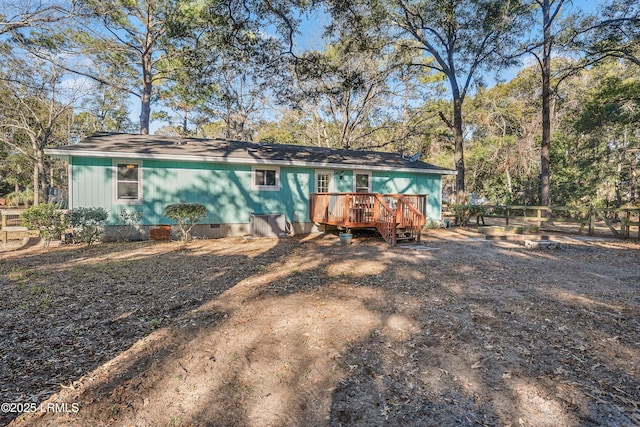 back of house featuring a wooden deck