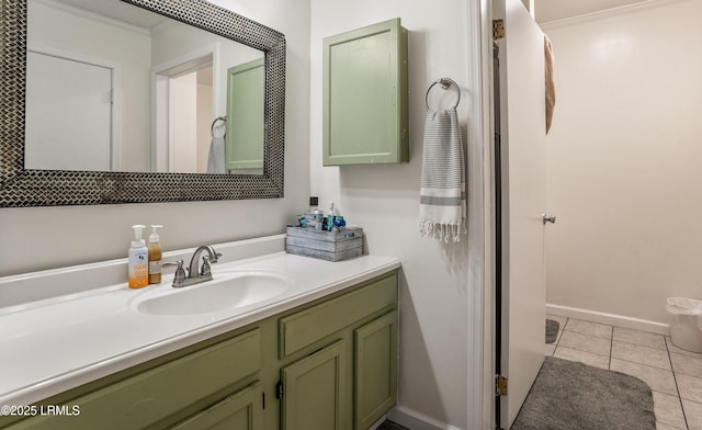 bathroom featuring tile patterned flooring, ornamental molding, and vanity