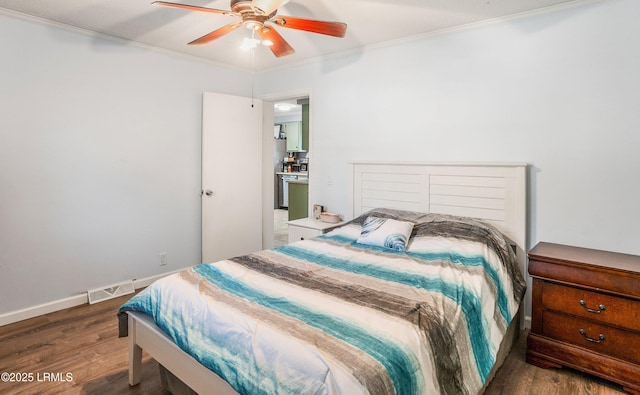 bedroom with dark wood-type flooring, ornamental molding, and ceiling fan