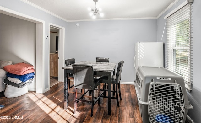 dining space featuring dark hardwood / wood-style flooring, ornamental molding, and an inviting chandelier