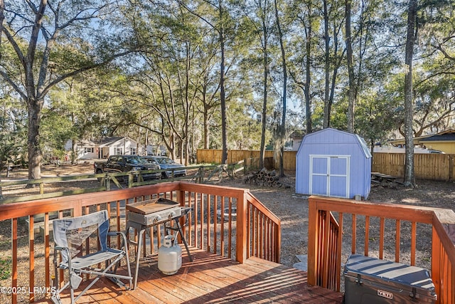 deck featuring a shed and a grill