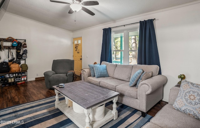 living room with crown molding, dark wood-type flooring, and ceiling fan