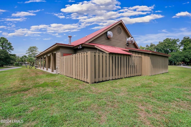 view of property exterior with a yard