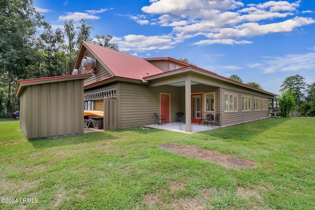 back of house featuring a yard and a patio area