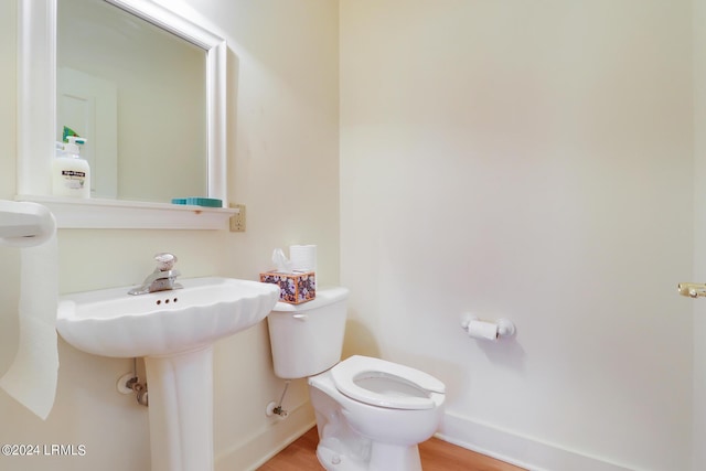 bathroom featuring hardwood / wood-style floors and toilet