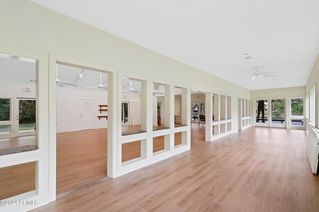 unfurnished sunroom featuring ceiling fan