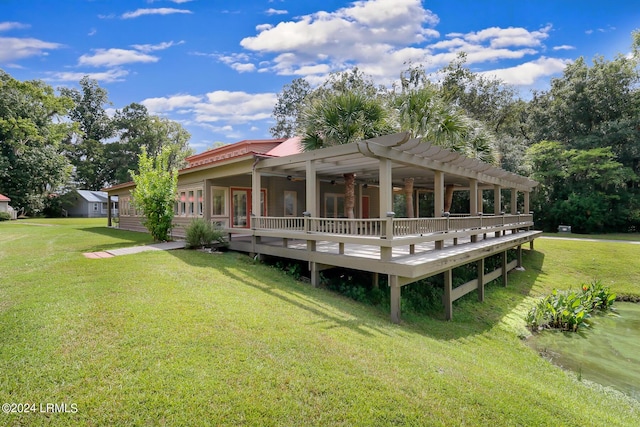 rear view of property featuring a yard, a deck, and ceiling fan