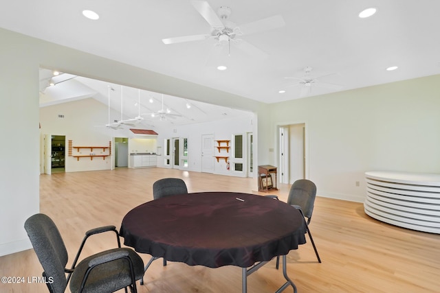 dining space featuring vaulted ceiling, ceiling fan, and light hardwood / wood-style flooring