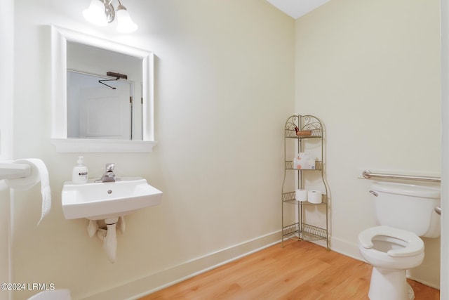 bathroom with wood-type flooring and toilet