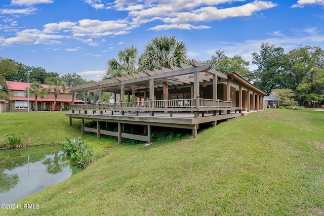 view of dock featuring a pergola, a deck, and a lawn