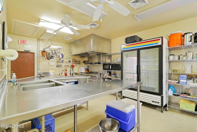 kitchen featuring sink, refrigerator, stainless steel counters, ceiling fan, and exhaust hood