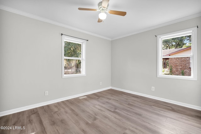 unfurnished room featuring ornamental molding, ceiling fan, and light wood-type flooring