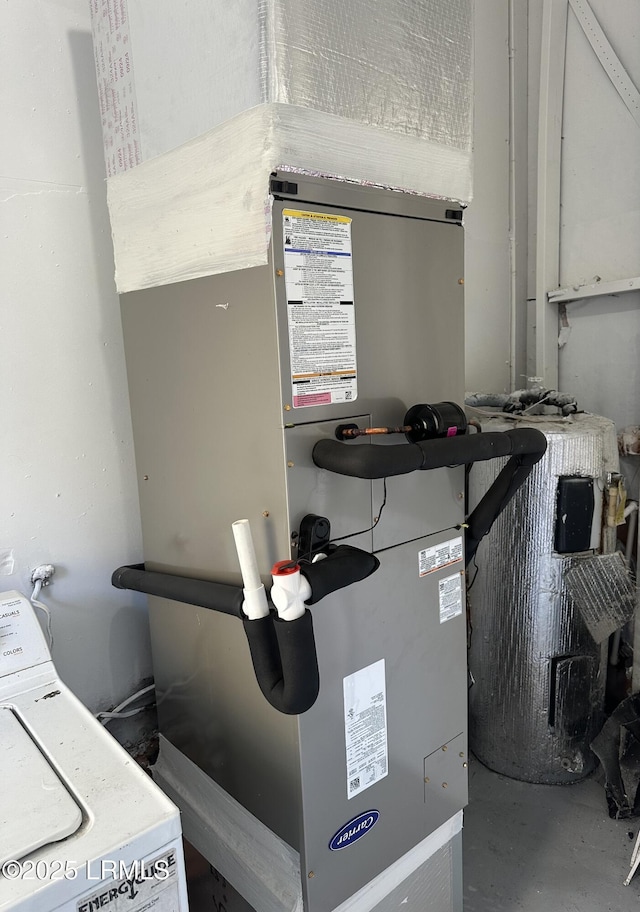 utility room featuring washer / dryer and heating unit