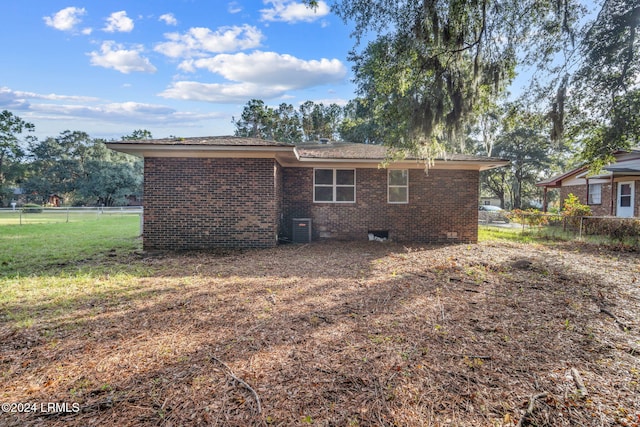 back of property featuring a lawn