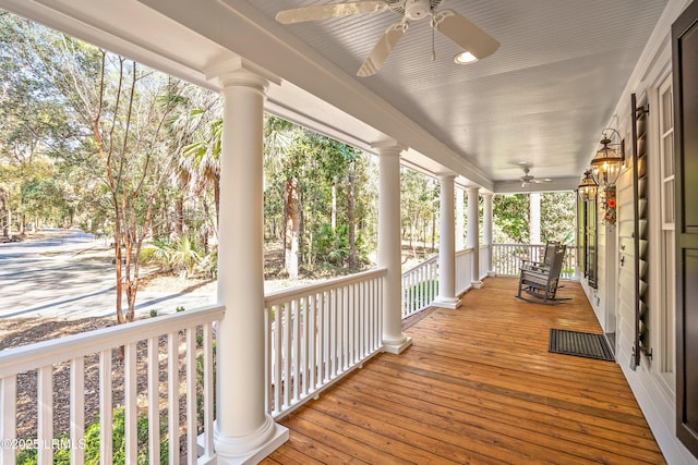 wooden terrace featuring ceiling fan and a porch