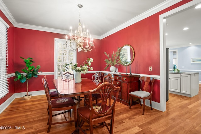 dining area featuring baseboards, ornamental molding, light wood-type flooring, a wealth of natural light, and an inviting chandelier