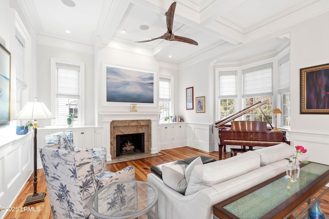 living area with ornamental molding, coffered ceiling, and beam ceiling