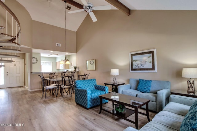 living room with ceiling fan, hardwood / wood-style flooring, high vaulted ceiling, and beamed ceiling