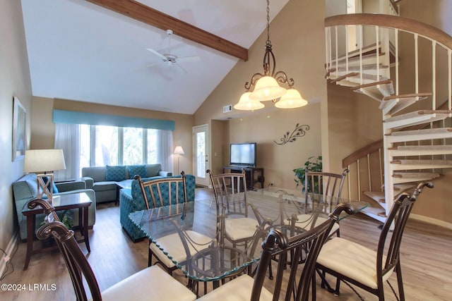 dining area featuring beamed ceiling, wood-type flooring, ceiling fan, and high vaulted ceiling