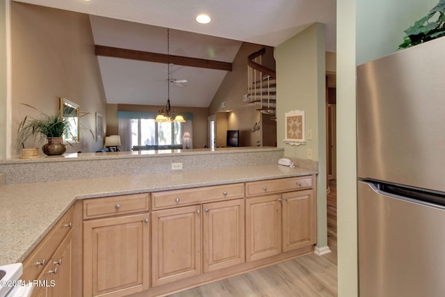 kitchen with an inviting chandelier, stainless steel refrigerator, light hardwood / wood-style floors, light stone countertops, and beam ceiling