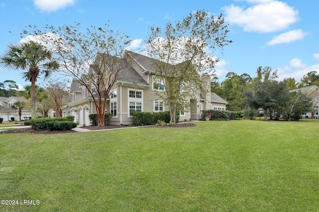 view of front of property featuring a garage and a front yard