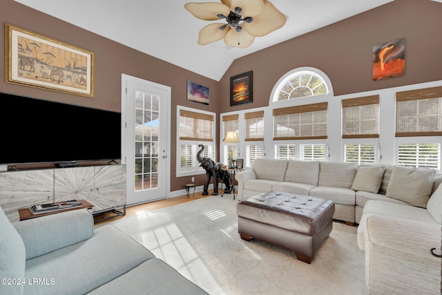 living room with vaulted ceiling, a wealth of natural light, and ceiling fan