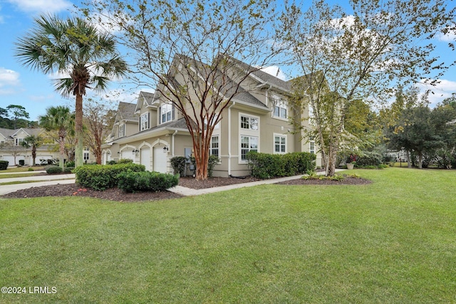 front of property with a garage and a front yard