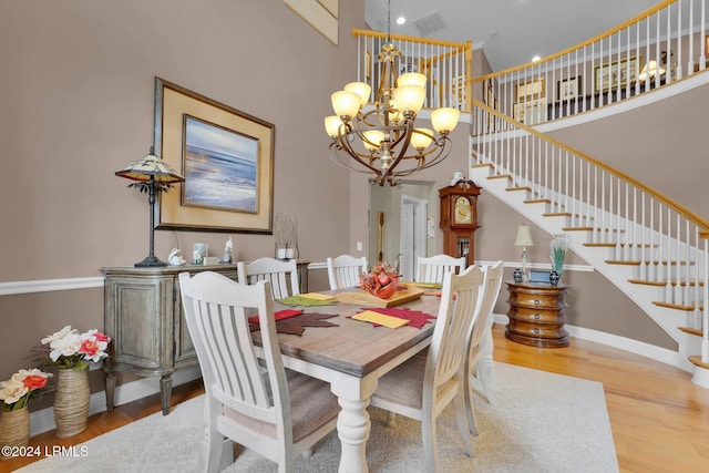 dining space featuring an inviting chandelier and light wood-type flooring