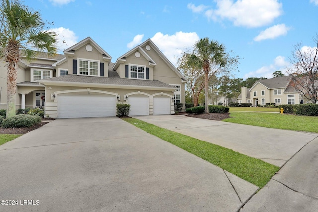 view of front of home with a garage and a front yard