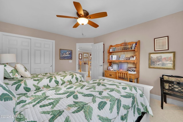 bedroom with light carpet, ceiling fan, and a closet