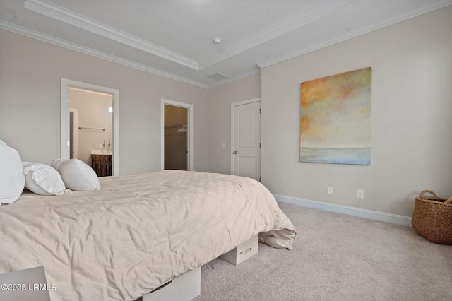 carpeted bedroom with ensuite bathroom, crown molding, and baseboards